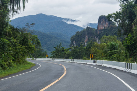 A curving, quiet road in the rolling countryside.