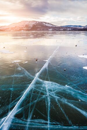 Beautiful ice on the lake at sunset. Winter landscapeの写真素材