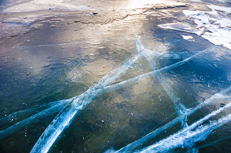Natural ice on the lake. Beautiful winter landscapeの写真素材