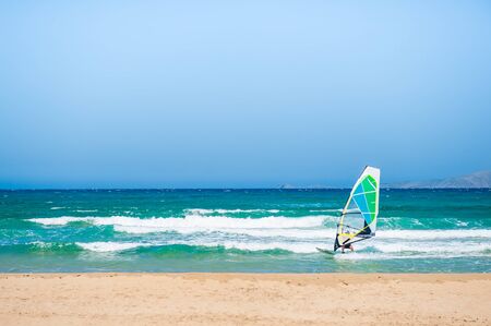 Windsurfing in the sea.Tropical beach with turquoise water and big waves.の写真素材