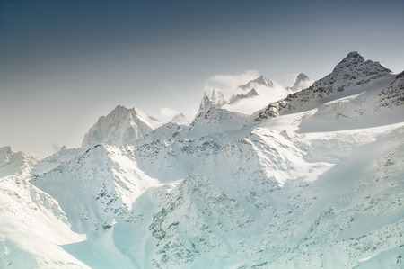 Winter snow-covered mountains at sunset. Beautiful winter landscapeの写真素材
