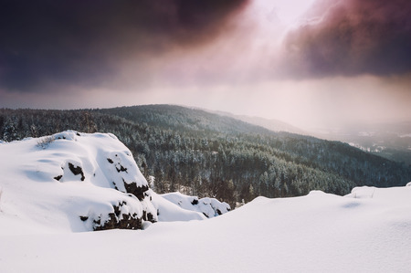 Fantastic winter landscape at sunset. Beautiful snow covered trees in the mountains. Winter forest