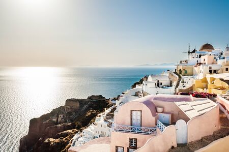 View of Oia town at sunset. White architecture on Santorini island, Greece. Beautiful landscape with sea viewの写真素材