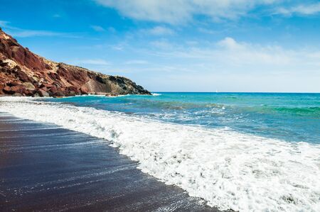 View of the seacoast and the beautiful Red beach. Santorini island, Greece. Bright turquoise water and the blue skyの写真素材