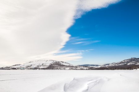 Winter landscape with snow-covered lakeの写真素材
