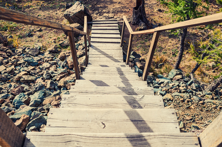 Wooden stairs on the hill leading down. Summer landscapeの写真素材
