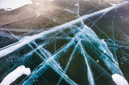 Natural ice on the lake. Beautiful winter landscapeの写真素材
