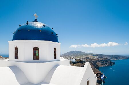 The Church in Imerovigli village. White architecture on Santorini island, Greece. Beautiful view on the seaの写真素材