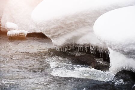 Melting snow on the mountain river. Beautiful winter landscapeの写真素材
