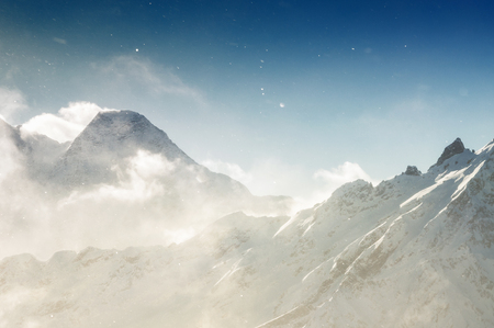 Winter snow covered mountains in the sunlight. Beautiful winter landscapeの写真素材
