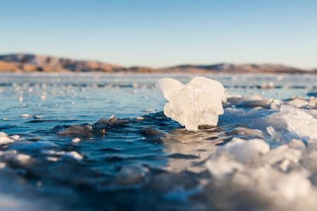 Beautiful ice on the lake at sunset. Winter landscape Small depth of sharpnessの写真素材