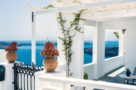 Greek house with terrace and sea view. White architecture on Santorini island, Greece.  Beautiful summer landscapeの写真素材