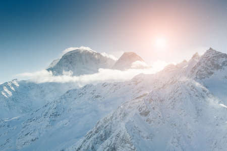 Sunset in the winter mountains. Beautiful winter landscape. Ski resort Elbrus. Caucasus, Russian Federation.の写真素材