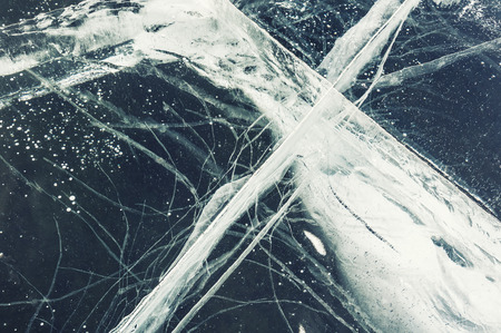 Natural ice with cracks and bubbles on the lake.