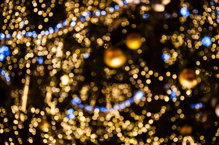 Blurred shiny background with gold lights and bokeh