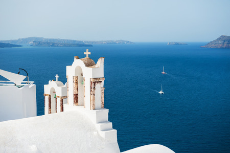 White church in Oia town on Santorini island, Greece. Beautiful landscape with sea viewの写真素材
