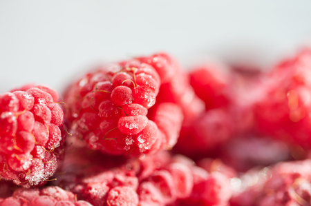 Frozen raspberry berries. Macro image with small depth of field. Beautiful berries background.の写真素材