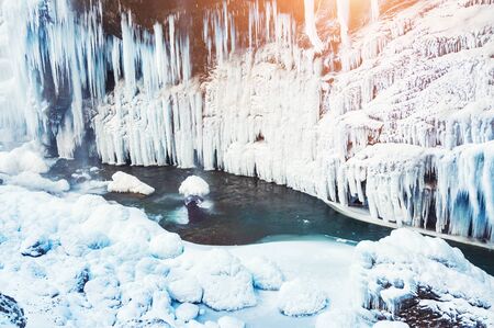 Frozen waterfall in the mountains. Beautiful winter landscape.の写真素材