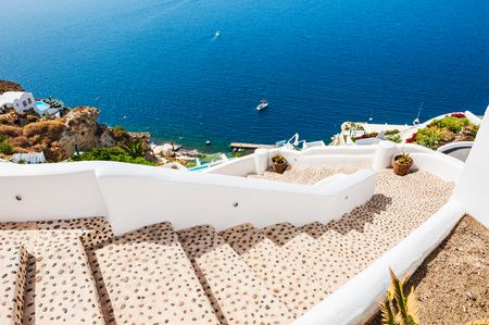 Stairs to the sea. White architecture on Santorini island, Greece. Beautiful landscape with sea view.の写真素材