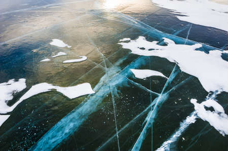 Natural blue ice on the frozen lake. Beautiful winter background.の写真素材