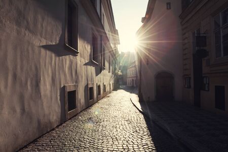 Old street in Prague at morning sunlight. Vintage filterの写真素材