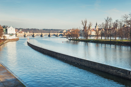 Embankment of the Vltava river and view of the Charles Bridge in Prague, Czech Republicの写真素材