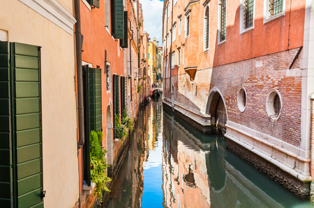 Scenic canal with colorful buildings in Venice, Italyの写真素材