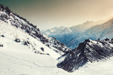 Mountain peaks at sunset. Beautiful winter landscapeの写真素材