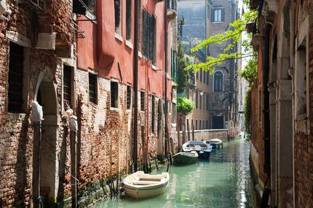 Scenic canal with ancient buildings in Venice, Italyの写真素材
