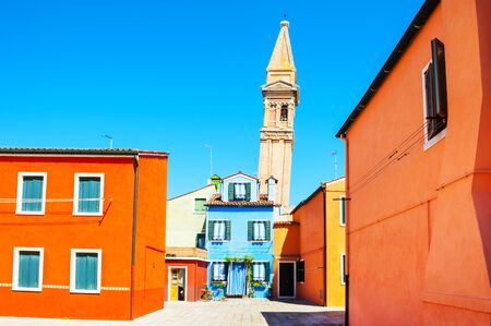 Leaning bell tower and colorful houses in Burano island near Venice, Italyの写真素材