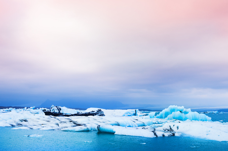 Big blue icebergs in Jokulsarlon glacial lagoon, South Iceland. Beautiful landscape at sunsetの写真素材