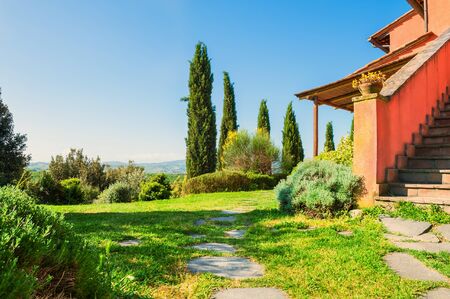 Green meadow of a country house. Beautiful Tuscany landscape, Italyの写真素材