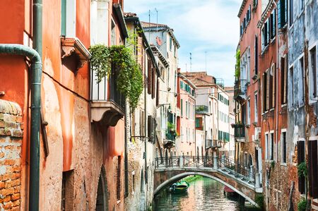 Scenic canal with colorful buildings in Venice, Italyの写真素材