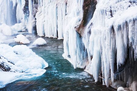 Frozen waterfall in the mountains. Beautiful winter landscape.の写真素材