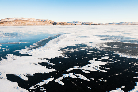 Ice and snow on the frozen lake. Beautiful winter landscapeの写真素材