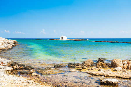 Beautiful beach and white chapel in the sea in Georgioupolis, Crete island, Greeceの写真素材