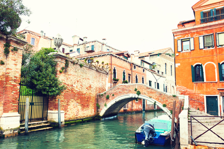 Scenic canal with bridge and ancient buildings in Venice, Italy. Vintage filterの写真素材