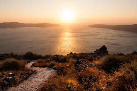 Beautiful sunset on Santorini island, Greece. Pathway to the seaの写真素材