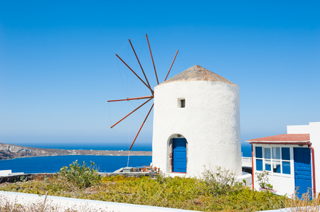 Old windmill on Santorini island, Greece. Summer landscape, sea view.の写真素材