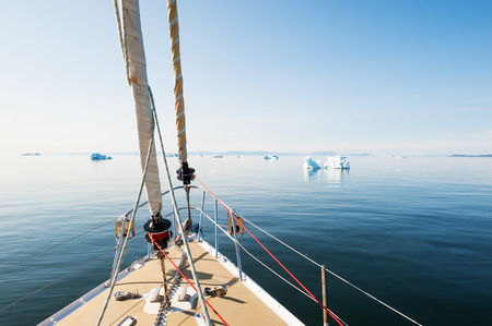 Travel by yacht in the Atlantic ocean among the icebergs in Greenlandの写真素材