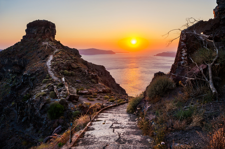 Beautiful sunset on Santorini island, Greece. Hiking trail in the mountainsの写真素材