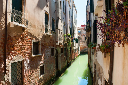 Scenic canal with ancient buildings in Venice, Italy.の写真素材