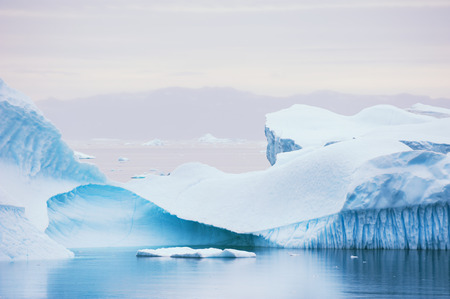 Big blue icebergs floating near the Saqqaq village, western Greenlandの写真素材