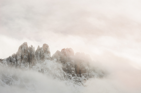 Mountain peaks in the clouds. Winter Dolomites, Val di Fassa, Italyの写真素材