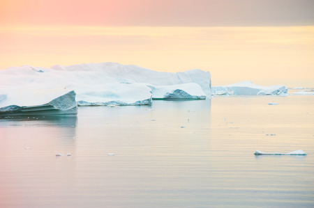 Big icebergs in western Greenland at sunsetの写真素材