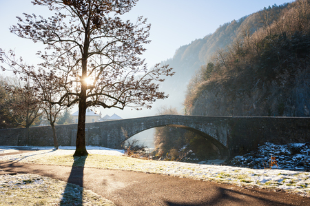 Beautiful landscape with ancient bridge in small town in French Alpsの写真素材