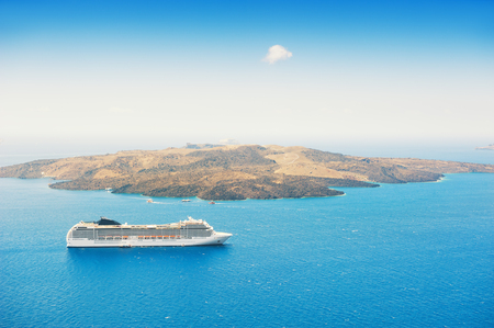 Cruise ship at the sea near the greek islands. Santorini island, Greece. の写真素材