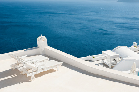 Two sunbeds on the terrace with sea views. Santorini island, Greece の写真素材