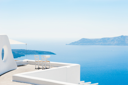 Two chairs on the terrace with sea views. Santorini island, Greece. Travel and vacation backgroundの写真素材