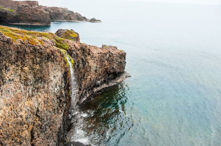 Waterfall on the coast of Disco island, western Greenlandの写真素材